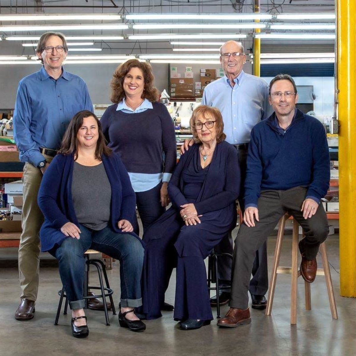 founding family sits for a portrait in factory